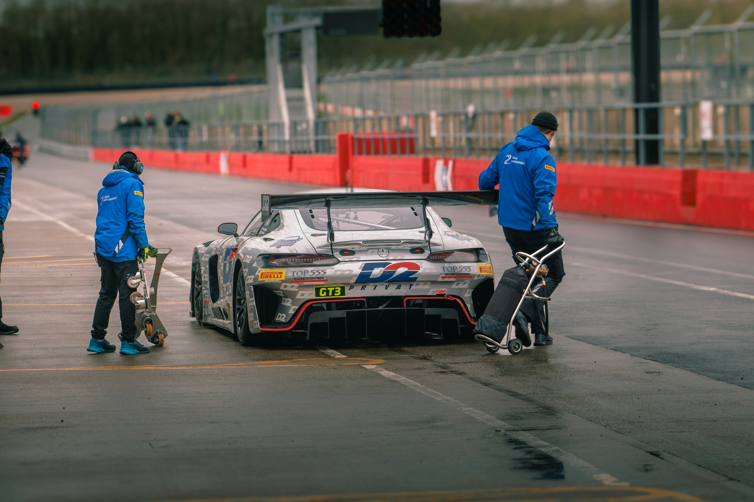 Mechanics preparing a race car in the garage